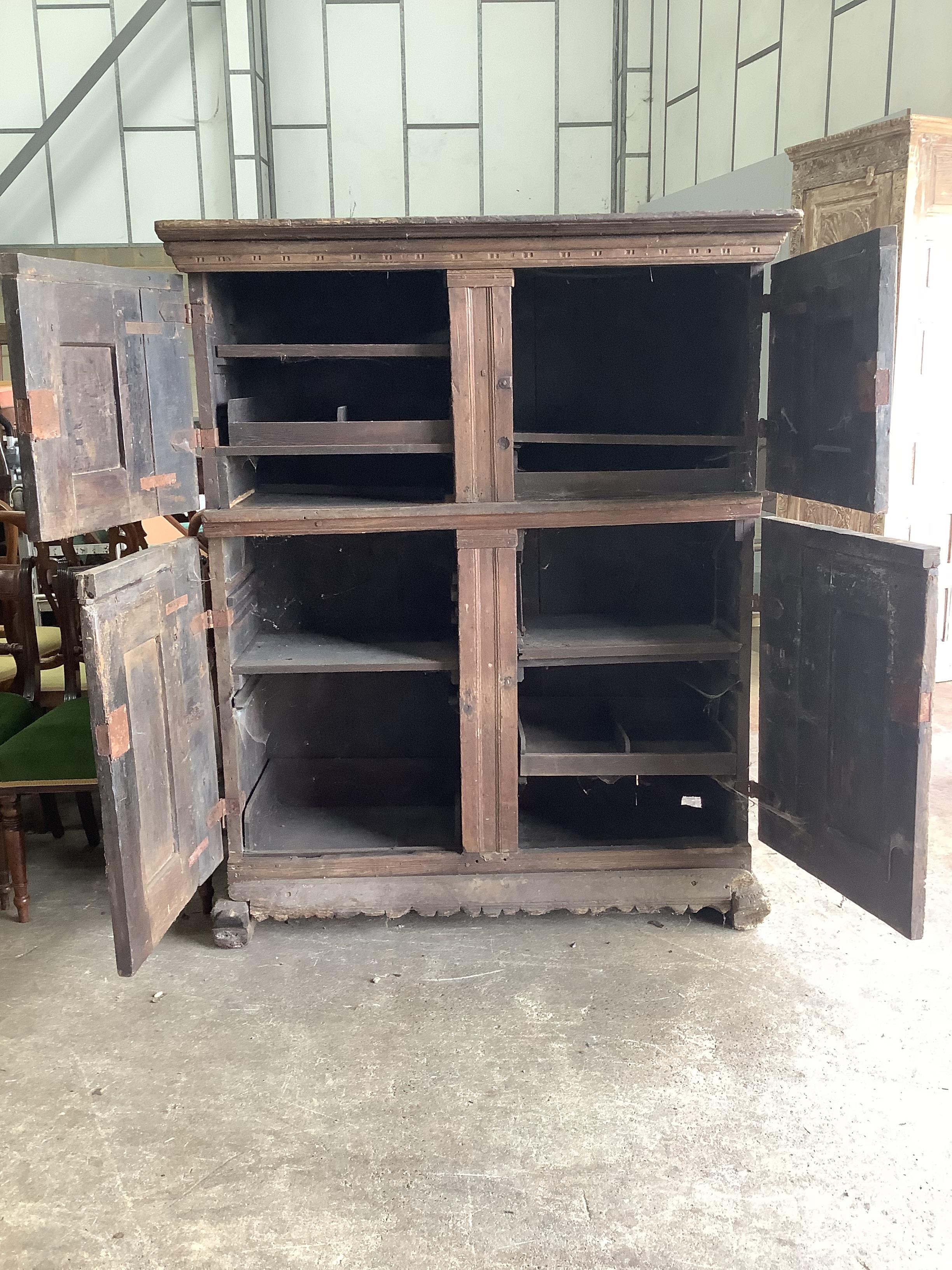 A Continental 17th century style oak four door hardwood cabinet, width 133cm, depth 60cm, height 162cm